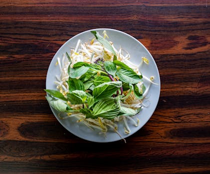 A colorful plate filled with leafy greens and beans